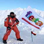 Nabil Al Busadi planting a DKT Fiesta condom flag on one of his summits.